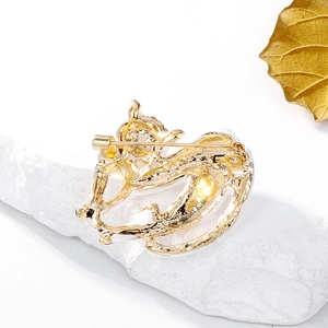 Golden cat brooch featuring a secure pin clasp closure on a polished metal back view