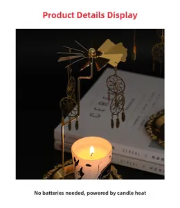 Close-up of golden rotating candle holder with dreamcatcher feather pendants and warm glow