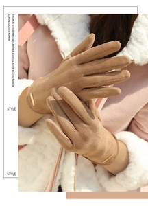 Close-up of camel faux suede winter gloves with elegant gold metal tag detail