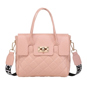 Pink quilted handbag with rhombic patterns, gold twist lock and jacquard strap