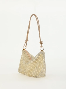 Close-up of golden rhinestone mesh handbag with knotted shoulder strap and metal ring