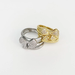 Fashionable gold and silver butterfly rings with sparkling zircon stones on white background