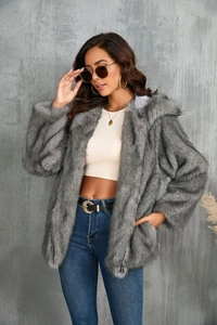 Détail de la texture en fausse fourrure grise sur une veste à capuche zippée