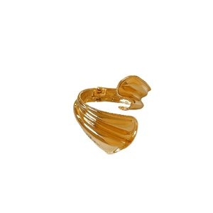 Minimalist gold irregular twisted metal open cuff bracelet with glossy textured finish