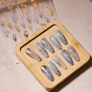 Detailed 5D press-on nail set with translucent purple base, gold foil, and floral art