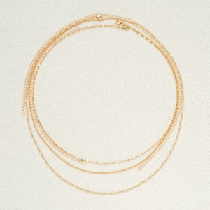 Detail of three-layer gold metal waist chains with sequins and lobster clasp