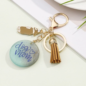 Dog Mom resin keychain with Corgi charm, brown tassel and golden keyring on flat lay