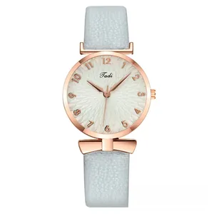 Macro shot of the white sunray dial with rose gold numerals and light blue leather strap