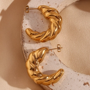 Macro shot of 18K gold plated hollow crescent croissant earrings with metallic texture