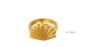 Detail view of a 1.3cm wide gold seashell ring showing sunburst texture on a white background