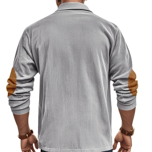Detail view of corduroy texture and brown elbow patches on the back of a grey polo shirt