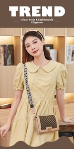 Detail of printed brown square crossbody bag with patterned wide strap on yellow dress