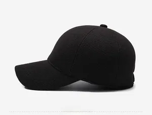 Side view of black wool flat cap for men with warm thick texture and metal logo
