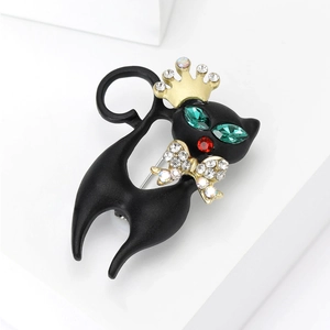 Elegant black enamel cat brooch with gold crown and sparkling green rhinestone eyes