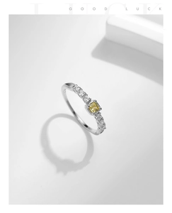 Close-up of S925 silver ring featuring a square yellow gemstone and side diamonds