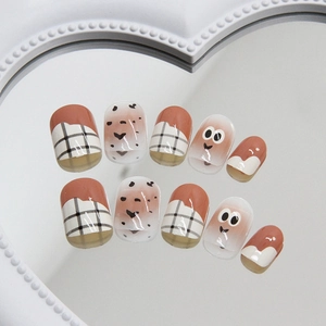 Cute brown and white press-on nails with eye patterns and checkered designs on heart mirror