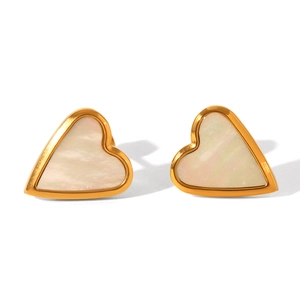 Close-up of heart-shaped gold studs featuring iridescent white mother of pearl inlay