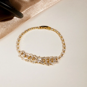 Detail of luxury gold bracelet with marquise and baguette zircon butterfly pattern