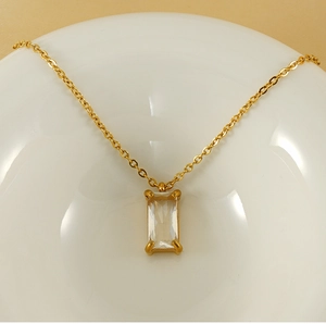 Macro shot of gold square zircon pendant with four-claw setting on 18K stainless steel chain