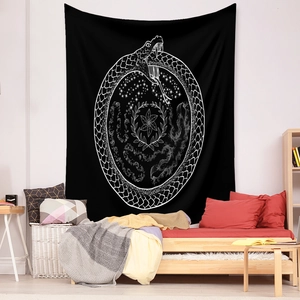 Detail of bohemian black tapestry with white Ouroboros snake and floral galaxy print