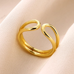 Macro shot of double-layer parallel gold ring with adjustable open design on satin fabric