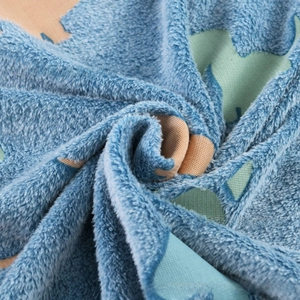 Close-up of soft blue and green glowing flannel fleece fabric with plush texture