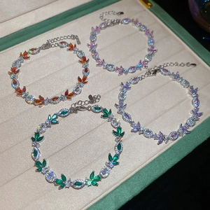 Macro detail of leaf-shaped sparkling cubic zirconia bracelets with lobster clasp and chain