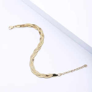Detailed shot of golden triple-braid snake chain bracelet with lobster clasp and extender