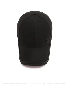 Close-up of black baseball cap showing the metallic NLS logo and leather brim edging