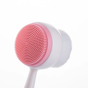 Standing double-sided facial brush with pink silicone massager and soft white bristles