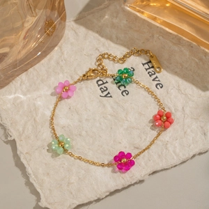 Detail of colorful beaded flower bracelet with gold chain and adjustable lobster clasp