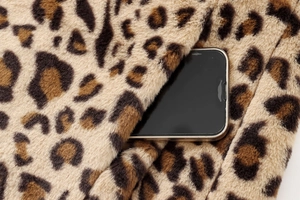 Detailed view of the functional side pocket on leopard print faux fur coat