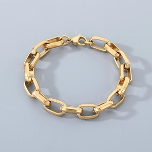 Detailed close-up of golden rectangular link chain bracelet with a secure lobster clasp