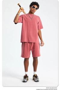 Detail of vintage washed pink cotton t-shirt with raw edges and drop shoulders on male model