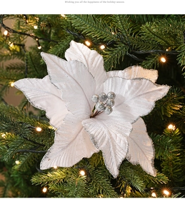 Close-up of white velvet Christmas flower with silver glitter edges and berry center