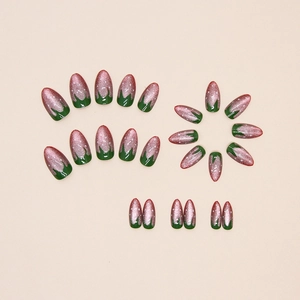 Deep green almond cat eye press-on nails with pink glitter and white strawberry dots