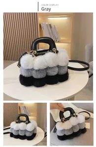 Close-up of grey gradient faux fur handbag with black leather handle and gold hardware