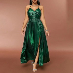 Detail of emerald green pleated evening gown with high leg slit and metallic finish