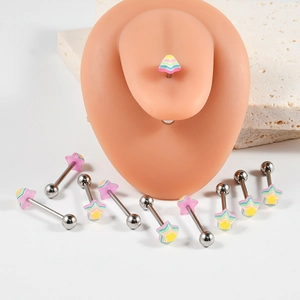 Macro detail of rainbow star surgical steel tongue rings on a silicone skin model