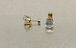 Macro view of 18k gold plated stainless steel stud earrings with six-prong zircon
