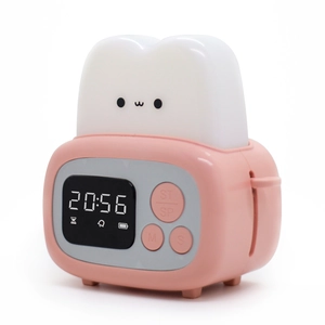 Pink toaster-shaped alarm clock and night light for kids on a white background