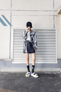 Street style fashion look featuring printed shirt, black skirt, and crew socks with sandals