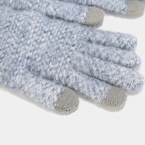 Detailed close-up of blue knit gloves featuring touchscreen fingertips and soft texture