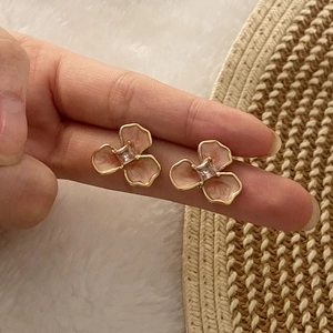 Pink enamel flower stud earrings with gold trim and clear cubic zirconia stones