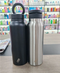 Detail of matte black and brushed stainless steel vacuum insulated bottles with handle lid