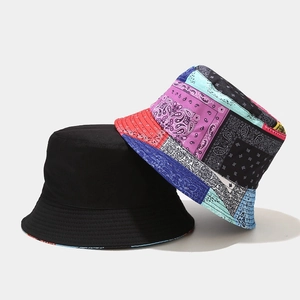 Double-sided paisley bucket hat featuring classic black and colorful patchwork canvas design