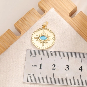 Macro shot of evil eye sunburst pendant in gold finish with size reference scale