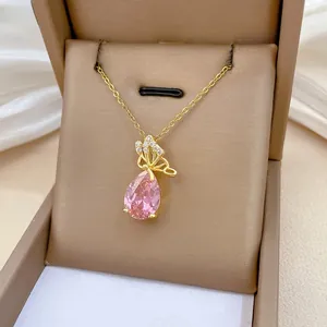 Detailed macro view of butterfly pink waterdrop gemstone necklace on luxury white silk