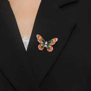Colorful enamel butterfly brooch with crystals pinned to a formal black suit lapel