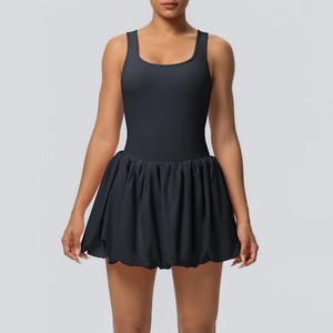 Detail view of the black pleated hem on a 2-in-1 athletic dress for yoga and fitness